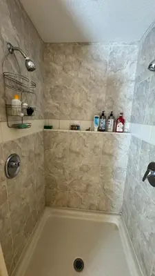 a bathroom with a shower with a large tub at Julian Barn-Partment in Santa Ysabel