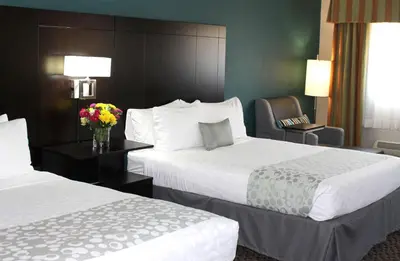 a hotel room with two beds and a chair at Best Western PLUS La Mesa San Diego in La Mesa