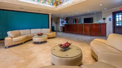 a waiting room with couches and a large screen at Best Western PLUS La Mesa San Diego in La Mesa