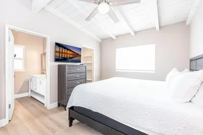 a white bedroom with a bed and a ceiling fan at Pet-Friendly 3Br W Oceanview Balcony, Only Steps To Sand By Beachview Rentals in Newport Beach