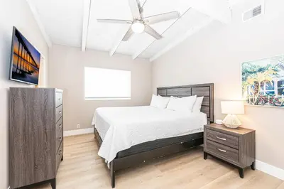 a bedroom with a bed and a ceiling fan at Pet-Friendly 3Br W Oceanview Balcony, Only Steps To Sand By Beachview Rentals in Newport Beach