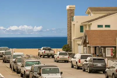 a bunch of cars parked on a street near the beach at Pet-Friendly 3Br W Oceanview Balcony, Only Steps To Sand By Beachview Rentals in Newport Beach