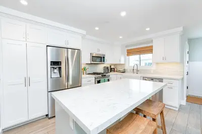 a kitchen with white cabinets and a white counter top at Luxury 1Br Retreat W High-End Interior - Steps From Beach By Beachview Rentals in Newport Beach