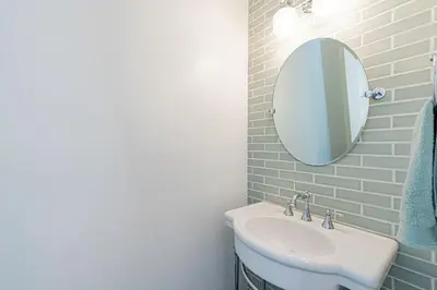 a bathroom with a sink and a mirror at Luxury 1Br Retreat W High-End Interior - Steps From Beach By Beachview Rentals in Newport Beach