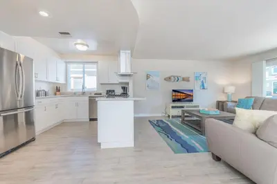 a kitchen and living room with a couch and a table at Spacious 3Br W Oceanview Patio, Steps To 35Th St Beach By Beachview Rentals in Newport Beach