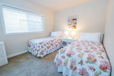 a bedroom with two beds and a window at Spacious 3Br W Oceanview Patio, Steps To 35Th St Beach By Beachview Rentals in Newport Beach