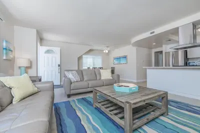 a living room with a couch and a coffee table at Spacious 3Br W Oceanview Patio, Steps To 35Th St Beach By Beachview Rentals in Newport Beach