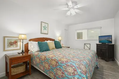 a bedroom with a bed and a ceiling fan at Cozy 2Br Oceanview, Half Block To Popular 29Th St Beach By Beachview Rentals in Newport Beach