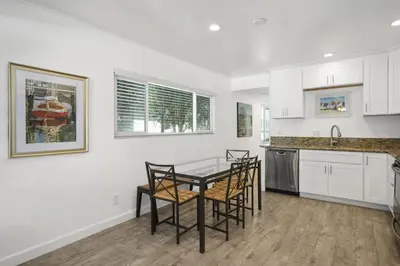 a kitchen with a table and chairs in it at Cozy 2Br Oceanview, Half Block To Popular 29Th St Beach By Beachview Rentals in Newport Beach