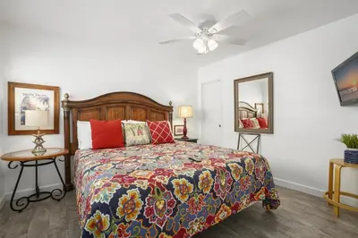 a bedroom with a bed and a ceiling fan at Cozy 2Br Oceanview, Half Block To Popular 29Th St Beach By Beachview Rentals in Newport Beach