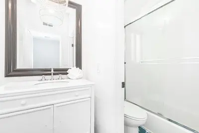 a white bathroom with a sink and a mirror at Remodeled 4Br Duplex, Steps From Beach And Boardwalk By Beachview Rentals in Newport Beach