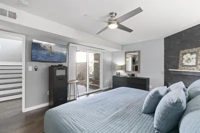 a bedroom with a bed and a ceiling fan at 6Br Oceanview Home W Rooftop Deck, Steps To 40Th St Beach By Beachview Rentals in Newport Beach