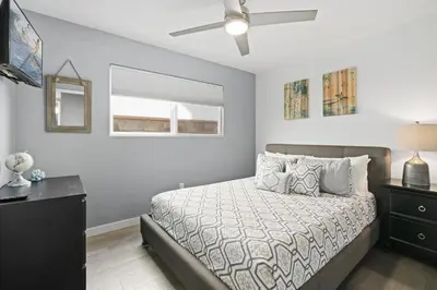 a bedroom with a bed and a ceiling fan at 6Br Oceanview Home W Rooftop Deck, Steps To 40Th St Beach By Beachview Rentals in Newport Beach