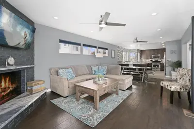 a living room with a couch and a fireplace at 6Br Oceanview Home W Rooftop Deck, Steps To 40Th St Beach By Beachview Rentals in Newport Beach