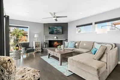 a living room with a couch and a fireplace at 6Br Oceanview Home W Rooftop Deck, Steps To 40Th St Beach By Beachview Rentals in Newport Beach