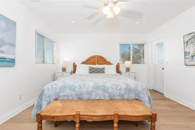 a bedroom with a bed and a ceiling fan at Spacious 4Br W Oceanview Balcony, Ac, Near 40Th St Beach By Beachview Rentals in Newport Beach