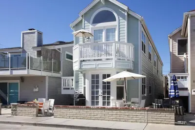 a large house with an umbrella in front of it at 3Br Oceanview W Prime Peninsula Location Near Beach By Beachview Rentals in Newport Beach