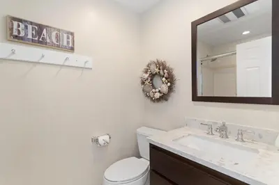 a bathroom with a toilet and a sink and a mirror at 3Br Oceanview W Prime Peninsula Location Near Beach By Beachview Rentals in Newport Beach
