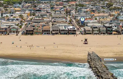 an aerial view of a beach with a crowd of people at Cozy 2Br W Ac And Private Patio, Steps To 40Th St Beach By Beachview Rentals in Newport Beach