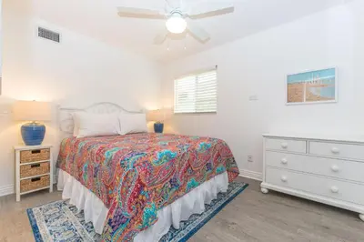 a bedroom with a bed and a ceiling fan at Updated 2Br W Ac, Huge Patio, And Grill, One Block To Sand By Beachview Rentals in Newport Beach