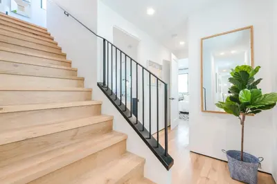 a staircase in a house with a potted plant at High-End Balboa Peninsula Home W Ac And Ocean Views By Beachview Rentals in Newport Beach
