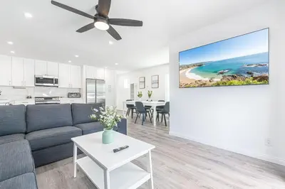a living room with a couch and a table at Modern 2Br W Oceanview Patio, Half Block To 29Th St Beach By Beachview Rentals in Newport Beach