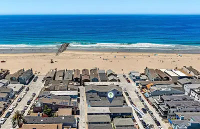 an aerial view of a beach with buildings and the ocean at Modern 2Br W Oceanview Patio, Half Block To 29Th St Beach By Beachview Rentals in Newport Beach