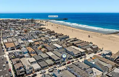 an aerial view of a beach with buildings and the ocean at Modern 2Br W Oceanview Patio, Half Block To 29Th St Beach By Beachview Rentals in Newport Beach