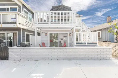 a large white house with a large patio at Modern 2Br W Oceanview Patio, Half Block To 29Th St Beach By Beachview Rentals in Newport Beach