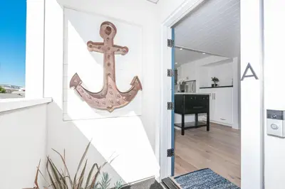 an anchor hanging on the wall of a house at 3Br Luxury Condo W Rooftop Deck, Fire Pit, Steps To Sand By Beachview Rentals in Newport Beach