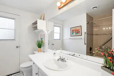 a white bathroom with a sink and a toilet at Pet-Friendly 3Br W Ac, Oceanview Patio, Steps From Beach By Beachview Rentals in Newport Beach
