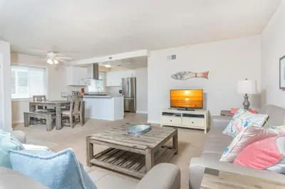 a living room with a couch and a table at Spacious 4Br W Oceanview Balcony, 3 Houses From The Beach By Beachview Rentals in Newport Beach