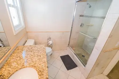 a bathroom with a shower and a toilet at Spacious 4Br W Oceanview Balcony, 3 Houses From The Beach By Beachview Rentals in Newport Beach