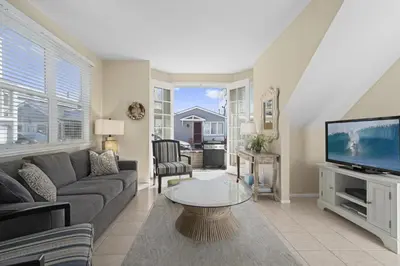a living room with a couch and a tv at 3Br Oceanview W Prime Peninsula Location Near Beach By Beachview Rentals in Newport Beach
