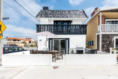 a house with a balcony with a table and chairs at Pet-Friendly 3Br Retreat W Large Patio Steps From Beach By Beachview Rentals in Newport Beach