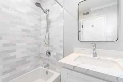 a white bathroom with a sink and a mirror at Pet-Friendly 3Br Retreat W Large Patio Steps From Beach By Beachview Rentals in Newport Beach