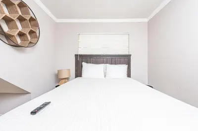 a bedroom with a bed with a remote control on it at Pet-Friendly 3Br Retreat W Large Patio Steps From Beach By Beachview Rentals in Newport Beach