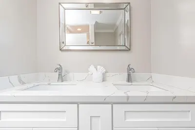 a white bathroom with two sinks and a mirror at Pet-Friendly 3Br Retreat W Large Patio Steps From Beach By Beachview Rentals in Newport Beach