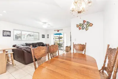 a living room with a table and a couch at Family-Friendly 2Br Beach Home In Prime Walkable Location By Beachview Rentals in Newport Beach