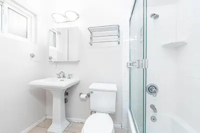 a bathroom with a toilet and a sink and a shower at Family-Friendly 2Br Beach Home In Prime Walkable Location By Beachview Rentals in Newport Beach