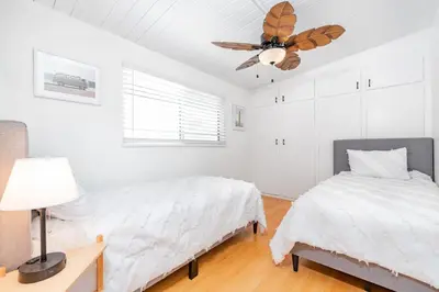 a bedroom with two beds and a ceiling fan at Upgraded Pet-Friendly Home Steps From Popular 40Th St Beach By Beachview Rentals in Newport Beach