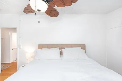 a white bedroom with a white bed and a ceiling at Upgraded Pet-Friendly Home Steps From Popular 40Th St Beach By Beachview Rentals in Newport Beach