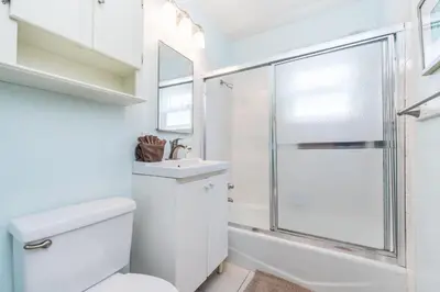 a bathroom with a shower and a toilet and a sink at Upgraded 5Br Summer Vacation Home, Steps From The Sand By Beachview Rentals in Newport Beach