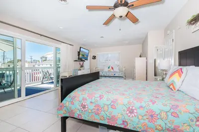 a bedroom with a bed and a ceiling fan at Upgraded 5Br Summer Vacation Home, Steps From The Sand By Beachview Rentals in Newport Beach