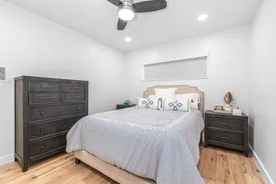 a bedroom with a bed and a dresser at Remodeled 3Br W Oceanview Patio, Ac, 4 Houses From Sand By Beachview Rentals in Newport Beach