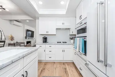 a kitchen with white cabinets and a sink at Remodeled 3Br W Oceanview Patio, Ac, 4 Houses From Sand By Beachview Rentals in Newport Beach