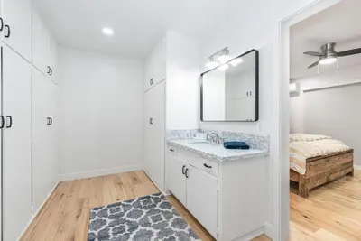 a white bathroom with a sink and a mirror at Remodeled 3Br W Oceanview Patio, Ac, 4 Houses From Sand By Beachview Rentals in Newport Beach