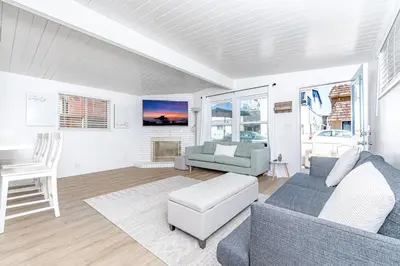 a living room with a couch and a chair at Renovated 2Br W Oceanview Patio Steps From 40Th St Beach By Beachview Rentals in Newport Beach