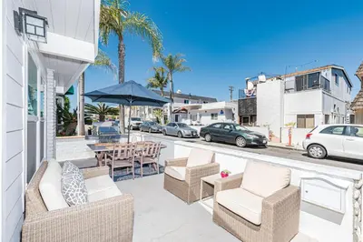 a patio with chairs and tables on a street at Renovated 2Br W Oceanview Patio Steps From 40Th St Beach By Beachview Rentals in Newport Beach