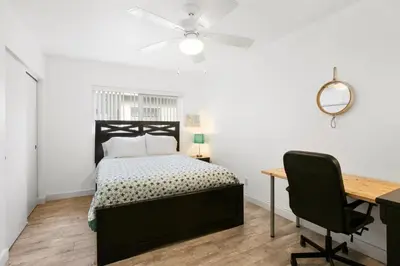 a bedroom with a bed and a desk and a chair at Charming Oceanview 3Br Half Block To 29Th St Beach By Beachview Rentals in Newport Beach